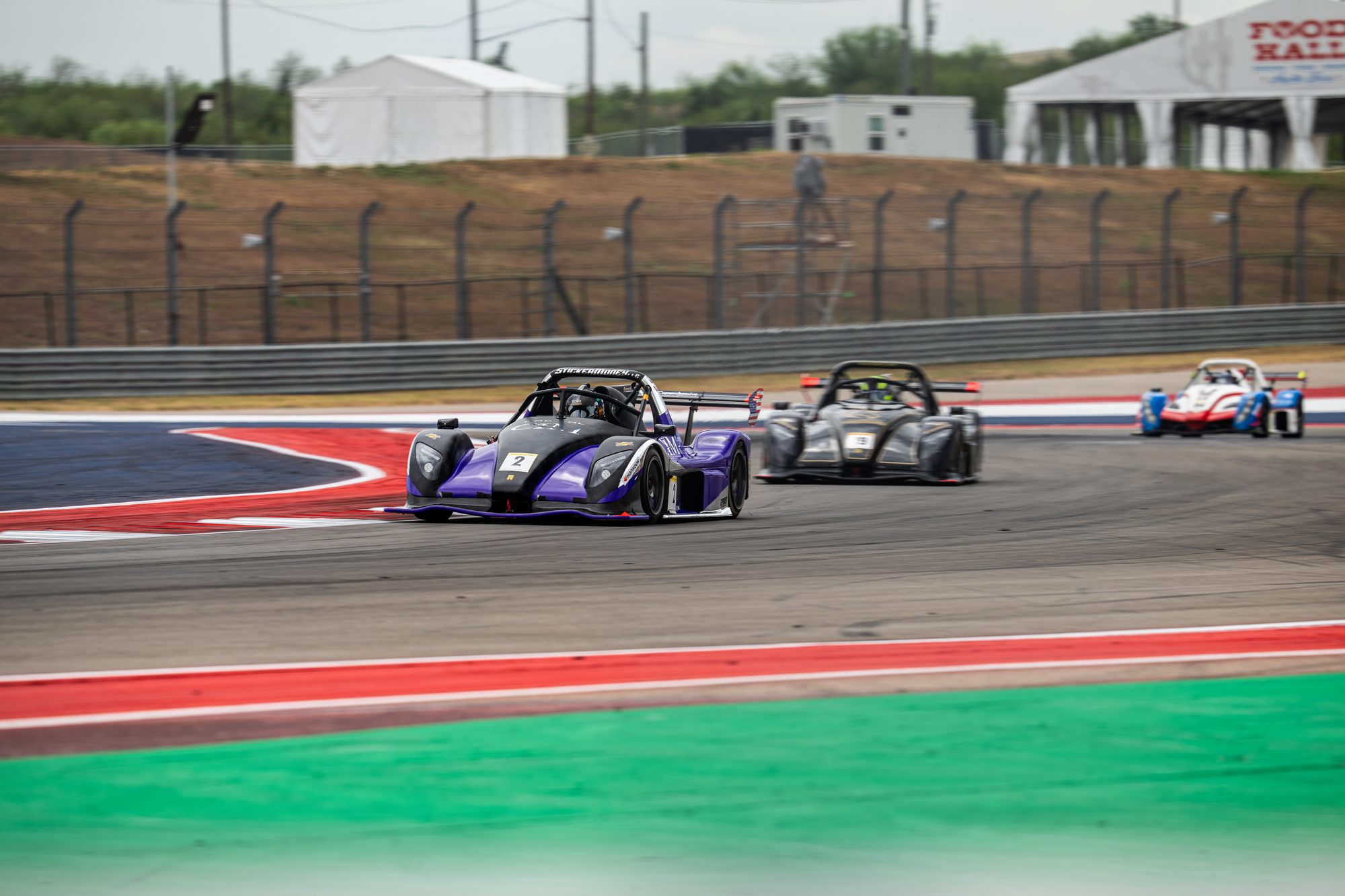 Purple Radical leading other prototypes through a corner at COTA