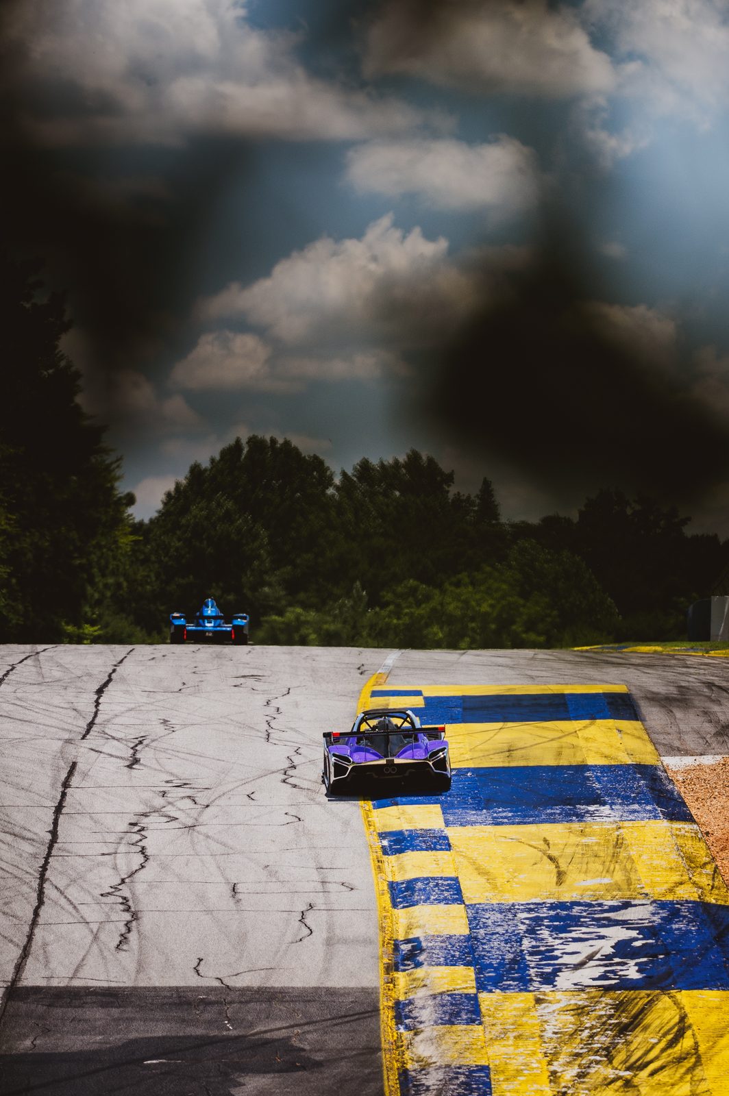 Purple Radical on the track under a dramatic storm sky
