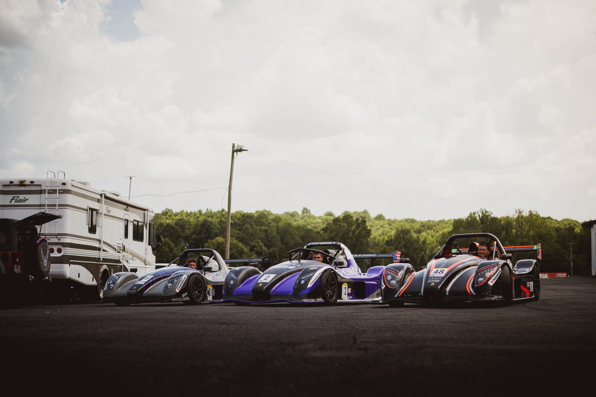 Three purple Radicals in the paddock